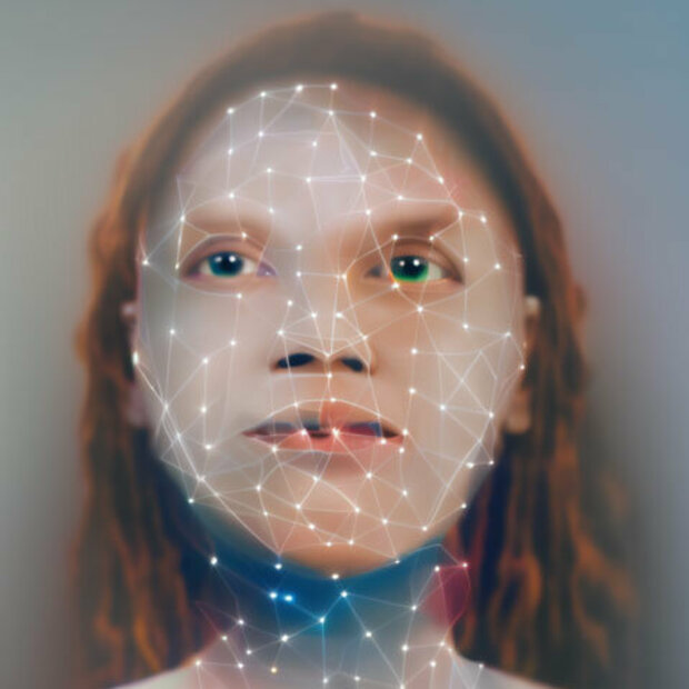 A woman's face is overlaid with a glowing facial-recognition mesh and connected points.