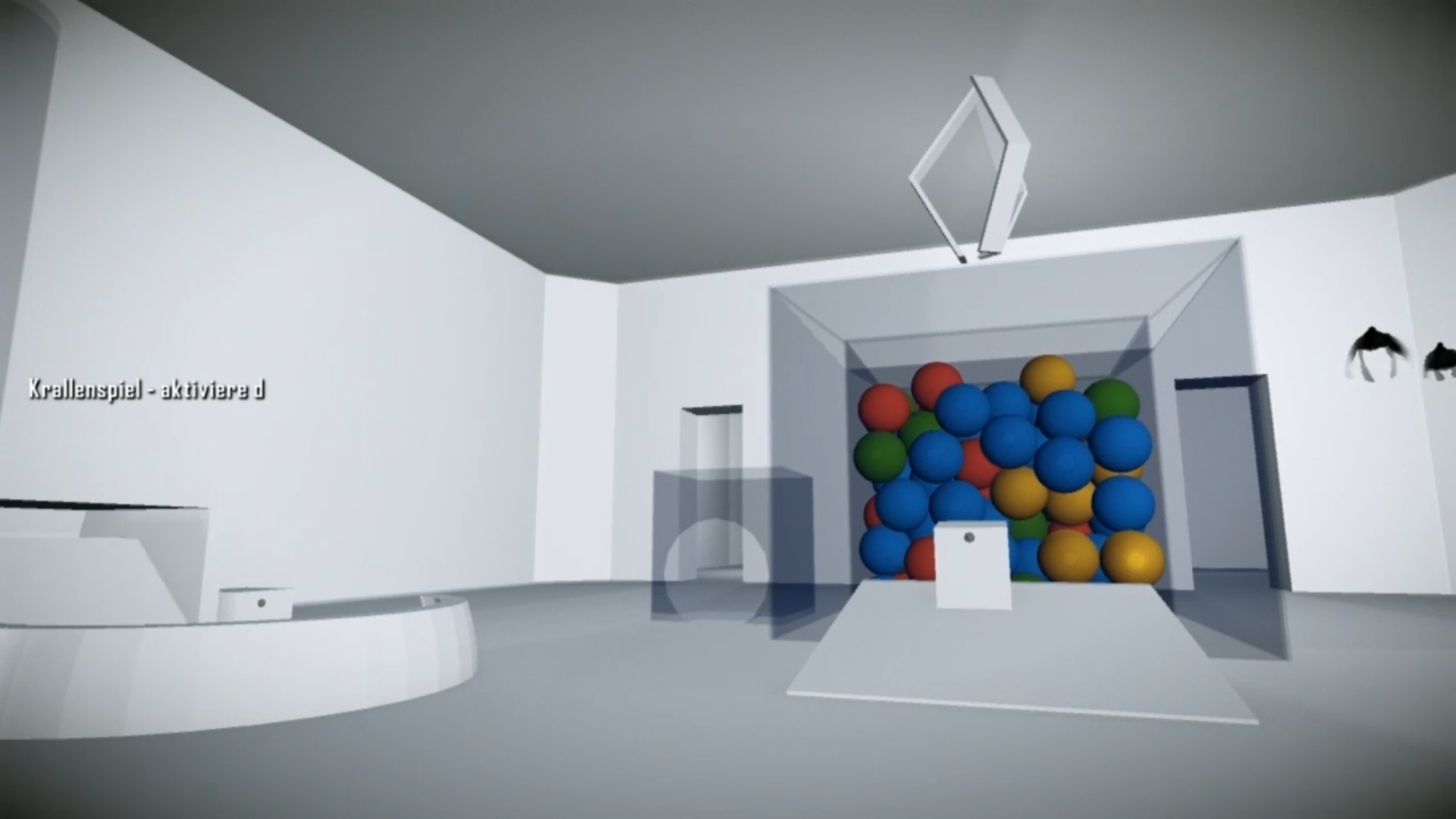 A minimalist 3D gallery with a bin of colorful spheres, a pedestal, and wall text in a white room.